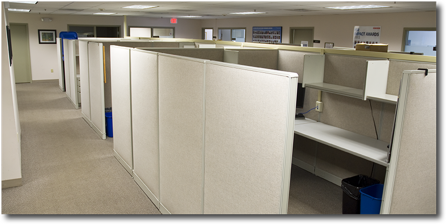Cubicles shown, with sorrounding private offices in background.